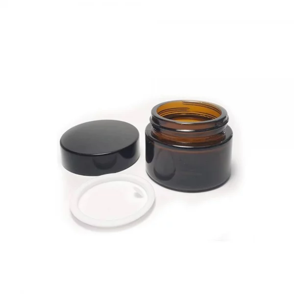 Tarro de vidrio ámbar de 50/30 ml con tapa negra y obturador, ideal para cremas y cosméticos.